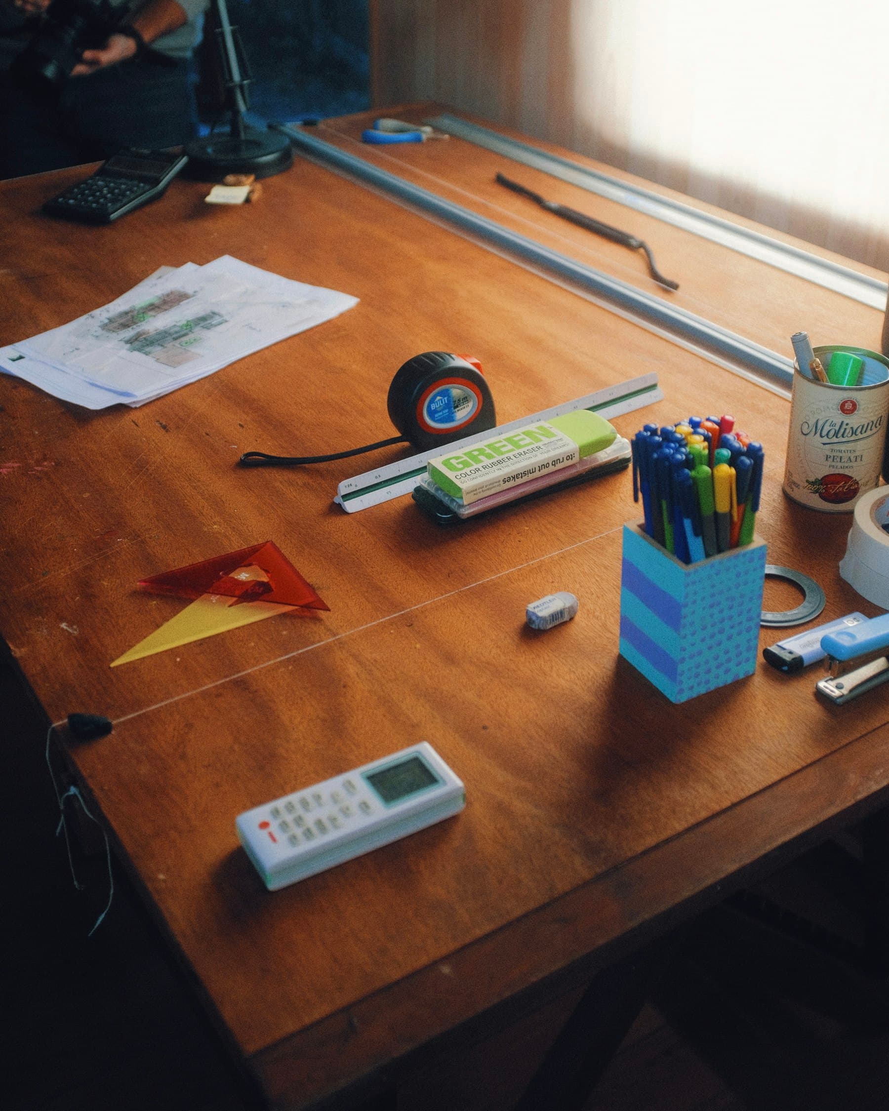 Plans and measuring tools on a worktable, representing careful analysis before implementation